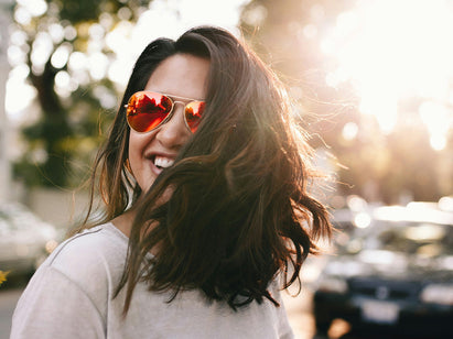 woman outside with black hair and glasses