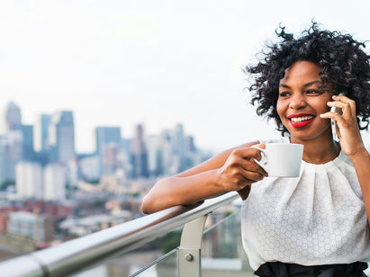 woman on her mobile having a drink