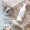 A bottle of Organic Children Quick Clean Hand Foam rests on a linen cloth surrounded by wooden toys and a dermatologically tested logo.