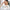 Thumbnail for Asiatische Frau trägt Feuchtigkeitspflege mit beiden Händen auf ihre Stirn auf, im Badezimmer, eine Kundenrezension im Vordergrund. image